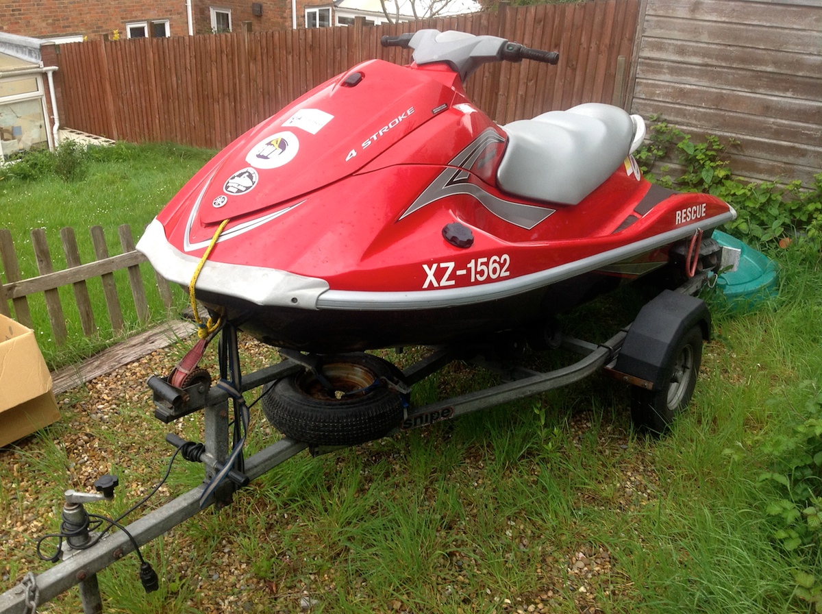 Red jet ski with trailer