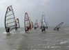 Sailors launch off the beach.